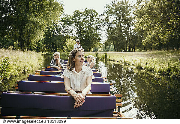 Tourists exploring Park Branitz sitting in boat on lake