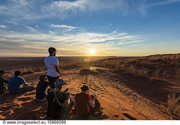 Tourists look out at the desert from Elim dune  Sesriem  Namib Desert; Namibia