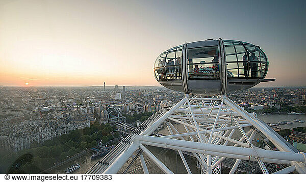 Tourists look out of the aerial view provided by the London Eye.
