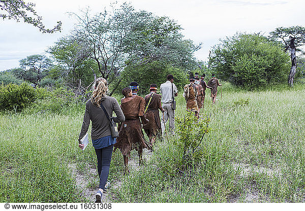 Tourists on a walking trail with members of the San people  bushmen.
