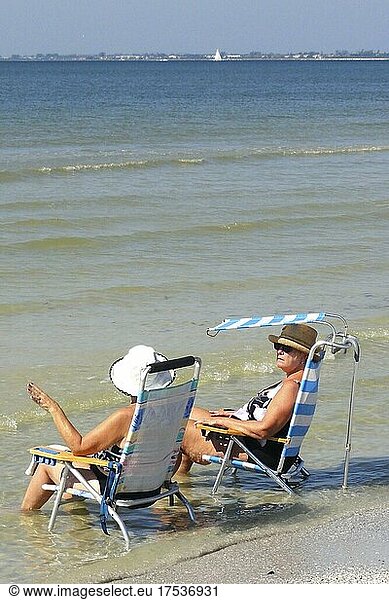 Tourists on sun lounger relaxing in the water  Fort Myers Beach  Florida  USA  North America
