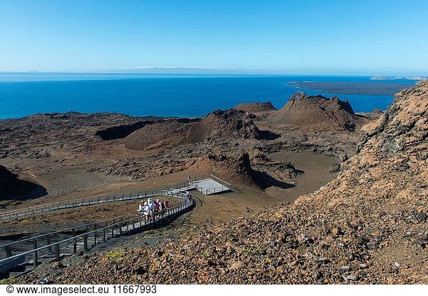 Tourists on the boardwalk in the lava landscape of Bartolome Island in the Galapagos Islands  Ecuador.