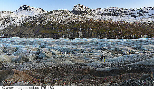 Tourists standing on glacier tongue  Iceland