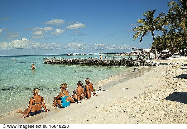 Tourists sunbathing at the sandy beach Playa Norte near the town center  Isla Mujeres  Cancun  Quintana Roo  Mexico  Central America.