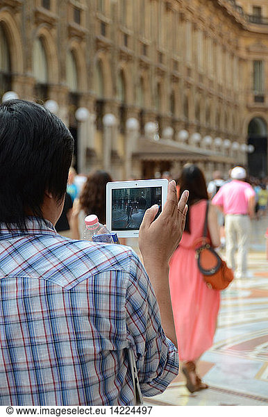 Tourists taking a photo  Vittorio Emanuele II gallery  city center  Milan  Lombardy  Italy  Europe