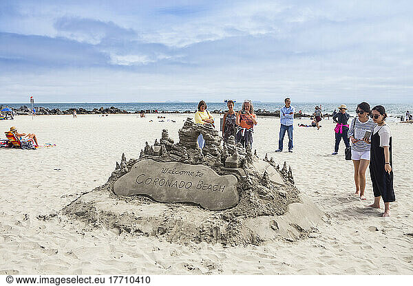 Tourists viewing a sandcastle on Coronado Beach; Coronado  California  United States of America