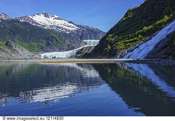 Tourists viewing Mendenhall Glacier and Nugget Falls in Mendenhall Park Recreation Area  near Juneau; Alaska  United States of America