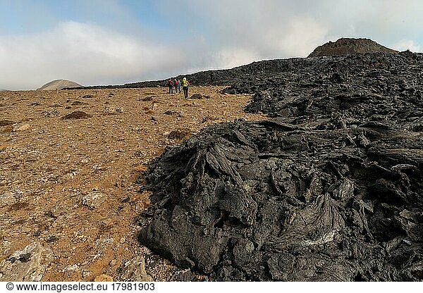 Tourists walk along cooled lava flows  extinct crater  Fagradalsfjall table volcano  Krýsuvík volcanic system  Reykjanes Peninsula  Iceland  Europe