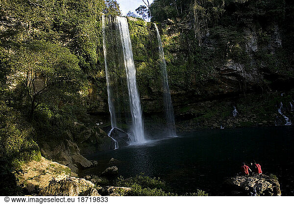 Tourists watch the sun set at the Misol Ha waterfall in Salto de Agua  Chiapas  Mexico