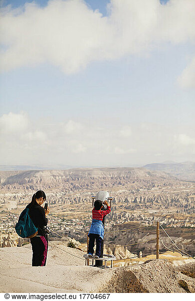 Tourists With A View From The Top Of Uchisar Castle; Uchisar  Cappadocia  Turkey