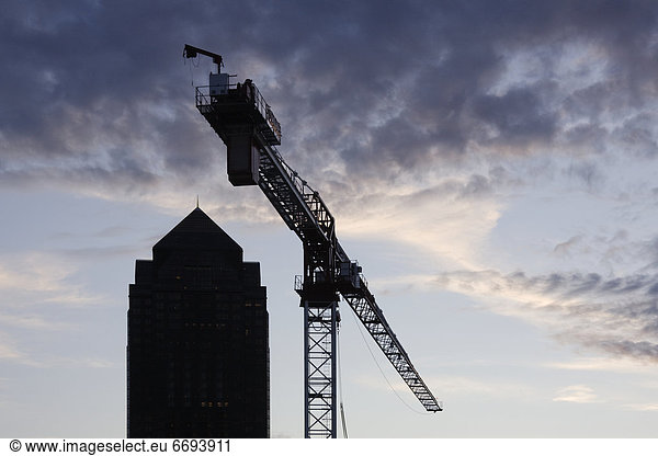 Tower Crane with Building Silhouette in Background