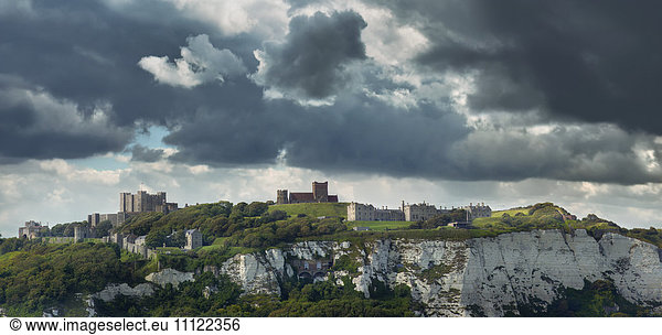 Town built on white cliffs under stormy sky  Dover  Kent  England