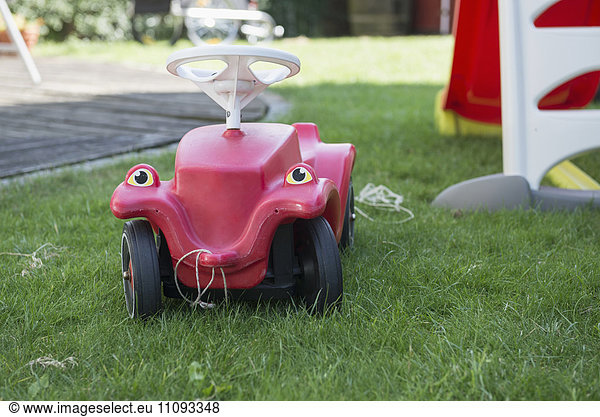 Toy car in lawn  Munich  Bavaria  Germany
