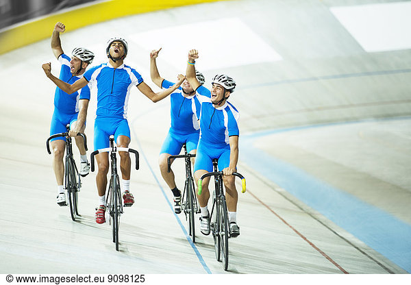 Track cycling team celebrating on track