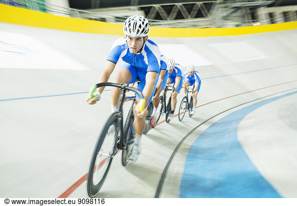 Track cyclist racing in velodrome