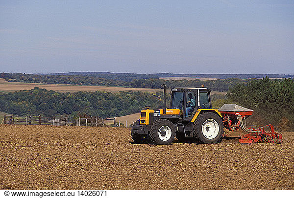 Tractor planting seeds in a field