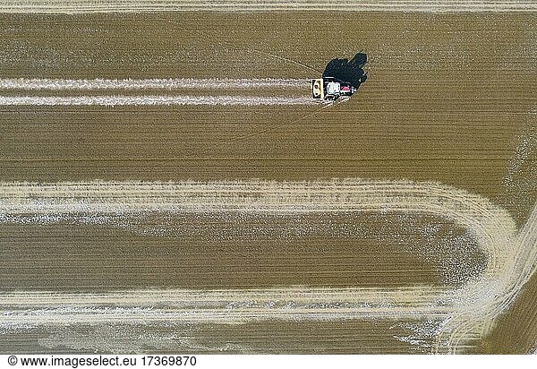 Tractor sowing rice seeds in a flooded rice field in May  aerial view  drone shot  Ebro Delta Nature Reserve  Tarragona province  Catalonia  Spain  Europe