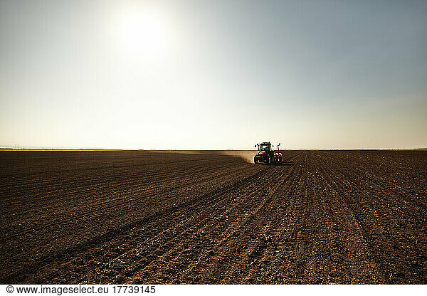 Tractor sowing seeds at soybean farm