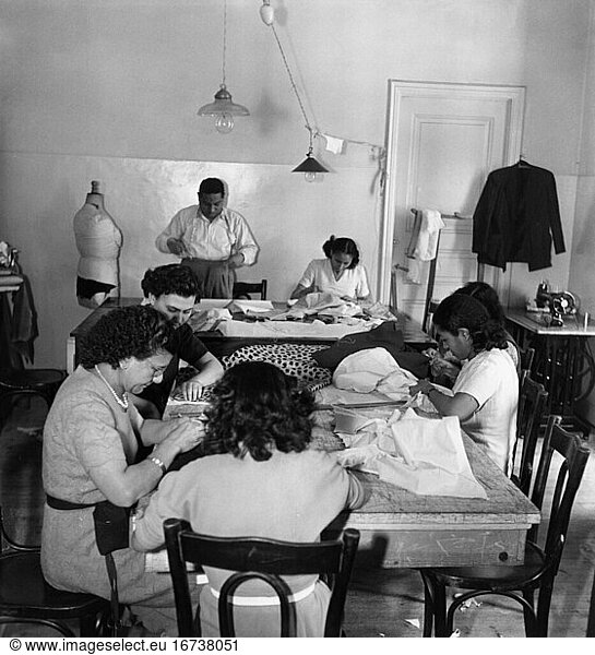 Trade and industry:
Tailor. View of a typical Egyptian tailor’s workshop: a tailor works with six seamstresses. Photo  1950.