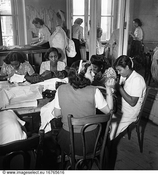 Trade and industry:
Tailor. View of a typical Egyptian tailor’s workshop: seamstresses at work. Photo  1950.