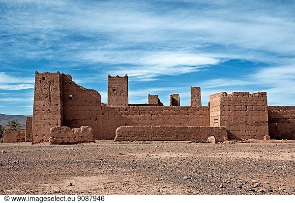 Traditional adobe kasbah in a small village  route between Zagora and Foum Zguid  Draa Valley  Morocco.
