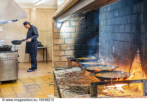 Traditional cooking of paella in restaurant kitchen