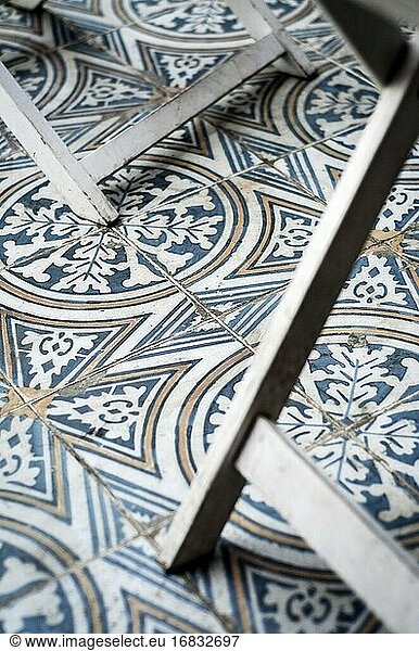 Traditional design old rustic floor tiles detail in seville andalucia cafe.