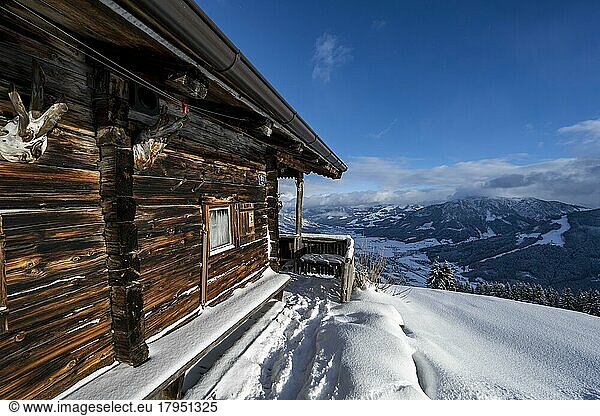 Traditional mountain hut in the snow  view into the valley  at the skiing area Bixen im Thale  Tyrol  Austria  Europe