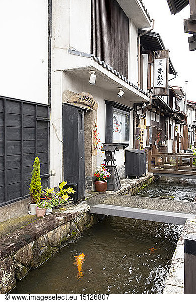 Traditional old Japanese houses on White Walled Storehouse Street along the carp filled Setogawa Canal in Hida Furukawa  Gifu Prefecture  Honshu  Japan  Asia