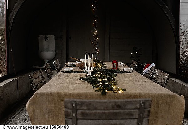 Traditional Scandinavian dinner table with fairy lights & candle