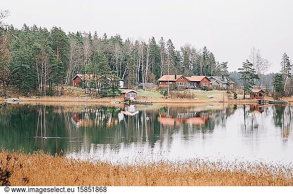 Traditional Swedish Scandinavian red house lined along the sea