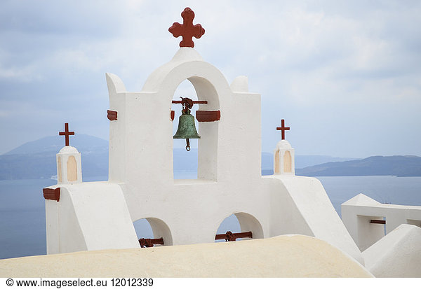 Traditional white bell tower of church on the island of Santorini  Greece.