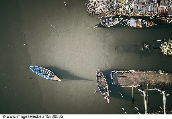 Traditional wooden fishing boats at sunset from aerial view