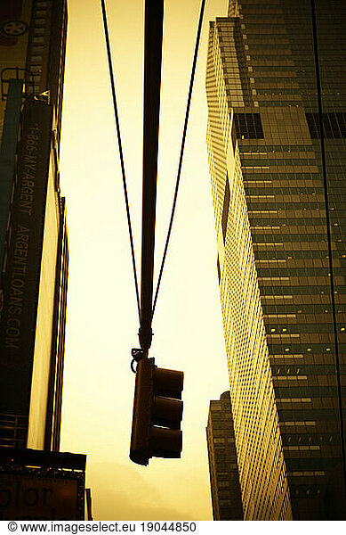 Traffic light between buildings.