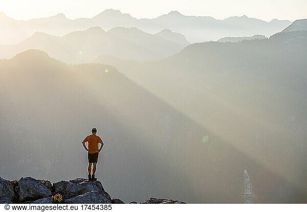 Trail runner standing on mountain summit near Vancouver  Canada.