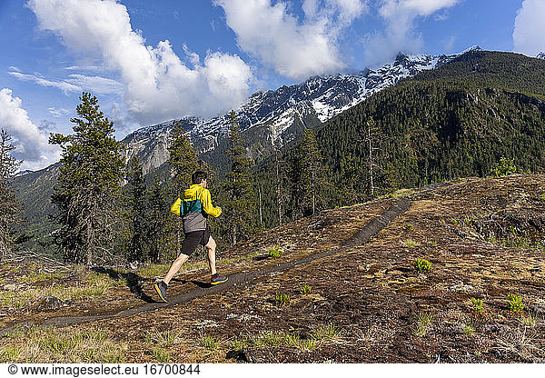 Trail running on a scenic alpine mountain trail in British Columbia.