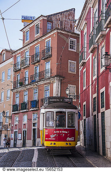 Tram passing in residential district of Alfama at Lisbon  Portugal