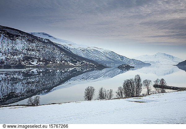 Tranquil lake and snow covered mountains Norway