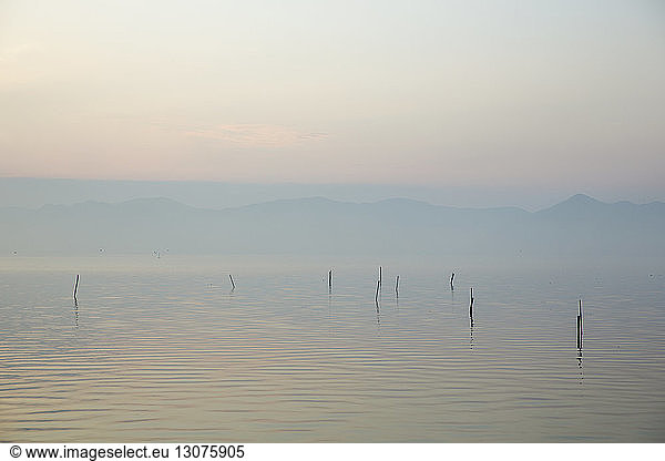 Tranquil scene of lake against sky during sunset