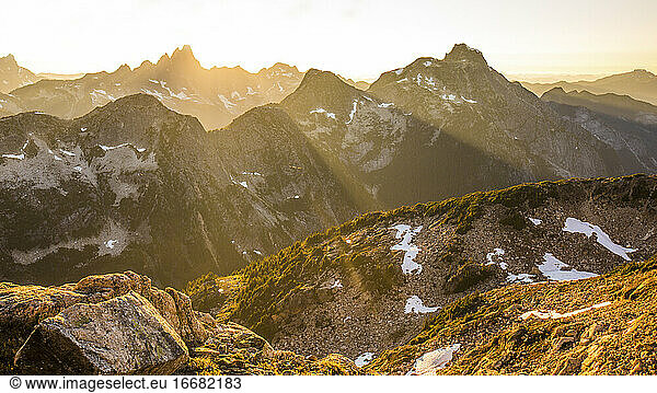 Tranquil scene of mountain range filled with rays of sunlight.