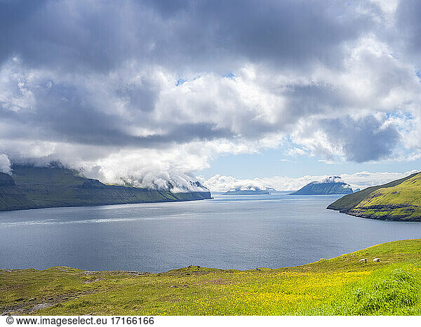 Tranquil view Vagar island by sea against cloudy sky  Iceland