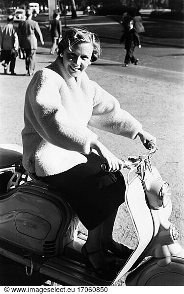Transport / Motor scooter. Young woman on a motor scooter. (Fashion shoot for Arlberg fur coats and jackets.)
Photo  undated (1950s).