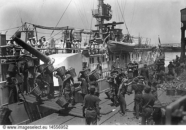 transport / transportation  navigation  warships  Germany  Reichsmarine 1922 - 1935  light cruiser Emden  launched and commissioned in 1925  first cruise as a training vessel  November 1926 - March 1928  coal is brought on board in Cape Town  South Africa  1920s  20s  20th century  historic  historical  military  German  fuel  turret  baskets  bearers  people