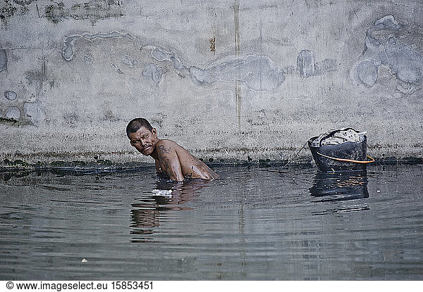 Trash keeper in the sewer of Bangkok canals