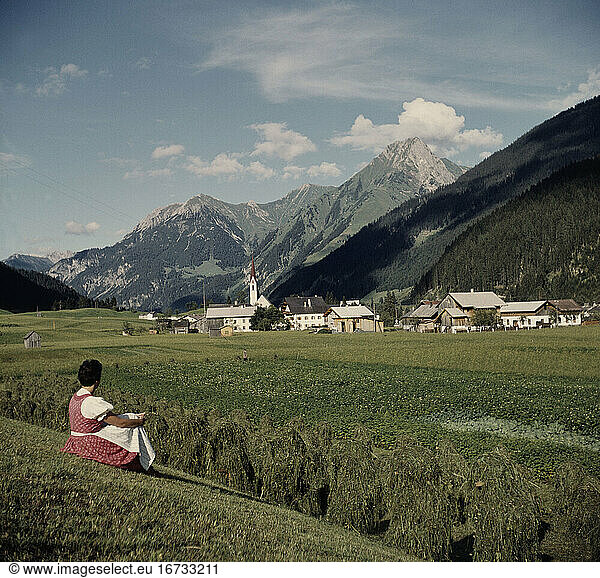 Travel and Recreation:
Mountains. Young woman in the Alps  enjoying the view. Photo  1960s.
