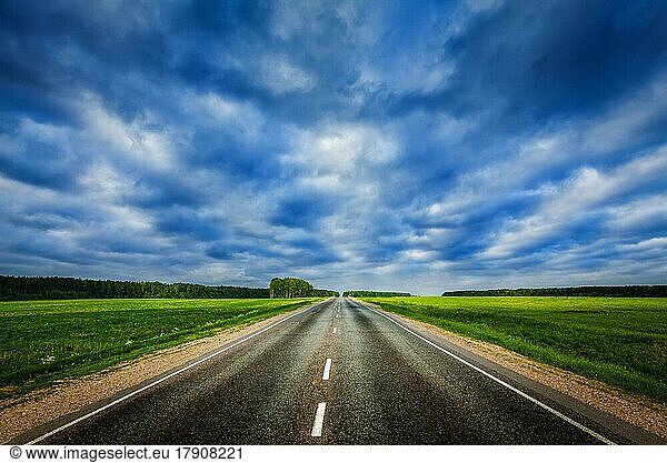 Travel concept background  road under dramatic stormy cloudy sky