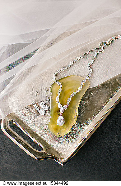 Tray and diamond necklace with yellow gemstone.