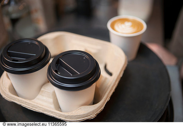 Tray of coffee in disposable cups in cafe