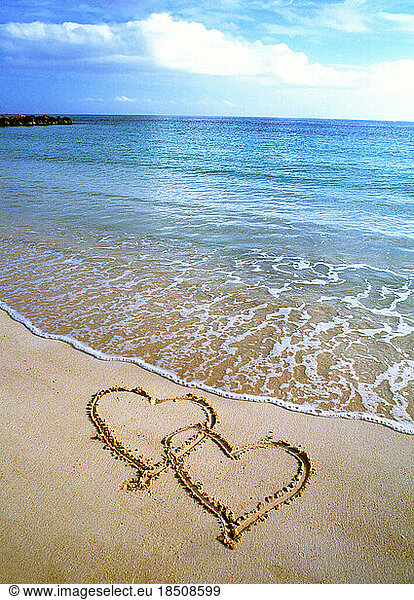 Tropical paradise Beautiful beach scene with hearts drawn in the sand