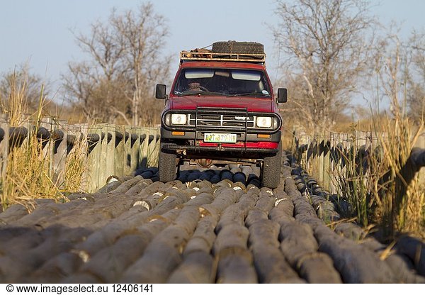 Truck crossing one of the access roads to the Third Bridge Camp in the Okavango Delta. Moremi Game Reserve  Botswana.